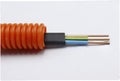three-core multicolored copper electric cable with protective corrugation Royalty Free Stock Photo