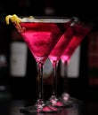 Three cosmopolitan drinks in line in bar on black Royalty Free Stock Photo