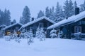 Three Cosy Wooden Houses with Christmas Tree in Front Located in Tranquil Picturesque Nordic Forest