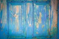 Texture of an old wooden turquoise door. the blue paint is peeling, cracked. vintage texture, background for your text Royalty Free Stock Photo