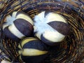 Three cotton pods displayed in an hand woven basket