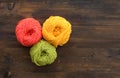 Three cotton yarn balls on wooden background. Copy space. Royalty Free Stock Photo