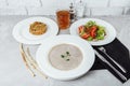 Business lunch from a plate with mushroom cream soup, with chicken and egg, a salad of fresh vegetables and pilaf Royalty Free Stock Photo