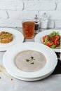 Business lunch from a plate with mushroom cream soup, with chicken and egg, a salad of fresh vegetables and pilaf Royalty Free Stock Photo