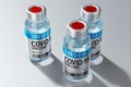 Three covid-19 / SARS-CoV-2 / coronavirus vaccine ampoules isolated on grey background