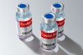 Three covid-19 / SARS-CoV-2 / coronavirus vaccine ampoules isolated on grey background