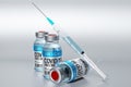 Three covid-19 / SARS-CoV-2 / coronavirus vaccine ampoules and syringe