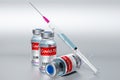 Three covid-19 / SARS-CoV-2 / coronavirus vaccine ampoules and syringe