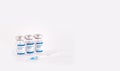 three Covid-19 vaccine vials with white background