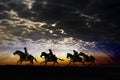 Cowboy riders under the sunset Royalty Free Stock Photo