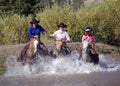 Three Cowgirls Crossing Pond Royalty Free Stock Photo