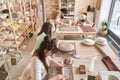 Three craftswomen concentrate on their ceramic projects in a work space Royalty Free Stock Photo