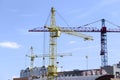 Three tower cranes at the construction site Royalty Free Stock Photo