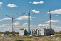 Three cranes in the construction of a new apartment building