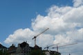 Three cranes among historical skyline of Zurich old town.