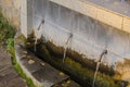 Three cranes in the stone wall, with clean water Royalty Free Stock Photo