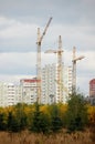 three cranes on top of high-rise building