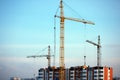 , three cranes on top of high-rise building Royalty Free Stock Photo