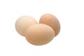 Three cream-colored chicken eggs on a white background