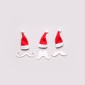 Three Creative Santa Claus portrait of paper mustache and hats. Minimal Christmas concept