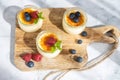 Three creme brulee desserts with baked sugar on a wooden board, decorated with fresh berries. Dessert for a snack. Home Royalty Free Stock Photo