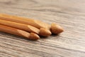 Three crochet hooks on wooden table, closeup Royalty Free Stock Photo