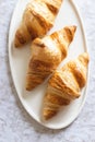 Three croissants on plate. Royalty Free Stock Photo