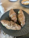 Three croissants on a round gray plate