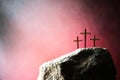 Three crosses against red sky on Calvary hill background. Crucifixion, resurrection of Jesus Christ. Christian Easter Royalty Free Stock Photo