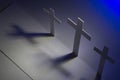 Crosses with shadows and a blue light in the corrner Royalty Free Stock Photo