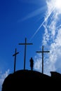 Three crosses on the hill and a boy praying Royalty Free Stock Photo