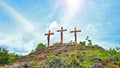 Three crosses of Jesus Christ on top of the hill with blue vibrant color sky with clouds background. Front view. Christianity.