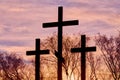 Three crosses in silhouette at sunset, dramatic sky Royalty Free Stock Photo