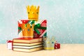 Three crowns of the three wise men with books,christmas gift boxes and snowflakes Royalty Free Stock Photo