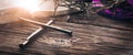 Three Crucifixion Spikes In Shape Of Cross On Wooden Table With Bible, Crown Of Thorns And Purple Robe