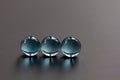 Three crystal blue marbles in a line showing window reflections - stock photo.jpg Royalty Free Stock Photo