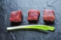 Three cubes of meat and green onions