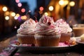 three cupcakes with frosting on a plate on a wooden table