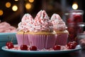 three cupcakes with pink frosting on a blue plate