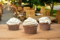 Three cupcakes on a wooden table Royalty Free Stock Photo