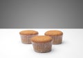 Three cupcakes on a wooden table Royalty Free Stock Photo