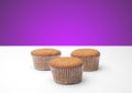 Three cupcakes on a wooden table Royalty Free Stock Photo