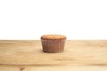 Three cupcakes on a wooden table Royalty Free Stock Photo