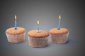 Three cupcakes on a wooden table Royalty Free Stock Photo