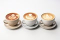 Three cups of coffee with latte art on white background