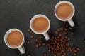 Three cups of coffee with milk on dark background Royalty Free Stock Photo