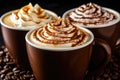 three cups of coffee with whipped cream on top are sitting on top of coffee beans Royalty Free Stock Photo