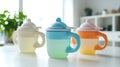 Three cups of different colors are lined up on a table Royalty Free Stock Photo