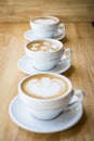 Three cups of hot cappuccino coffees Royalty Free Stock Photo