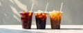 Three cups of iced coffee mockup with colored straws on a white background. Royalty Free Stock Photo